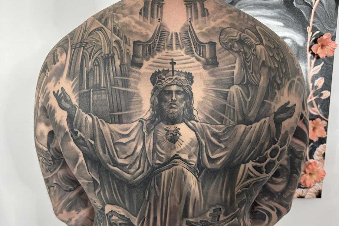 A man wearing a full-back religious tattoo A man wearing a full-back religious tattoo