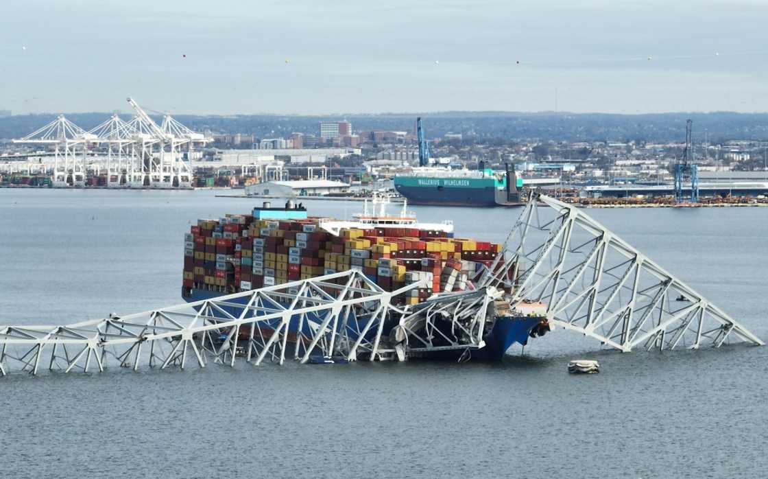 In this aerial image, the steel frame of the Francis Scott Key Bridge sits on top of a container ship after the bridge collapsed in Baltimore, Maryland on March 26, 2024 In this aerial image, the steel frame of the Francis Scott Key Bridge sits on top of a container ship after the bridge collapsed in Baltimore, Maryland on March 26, 2024
