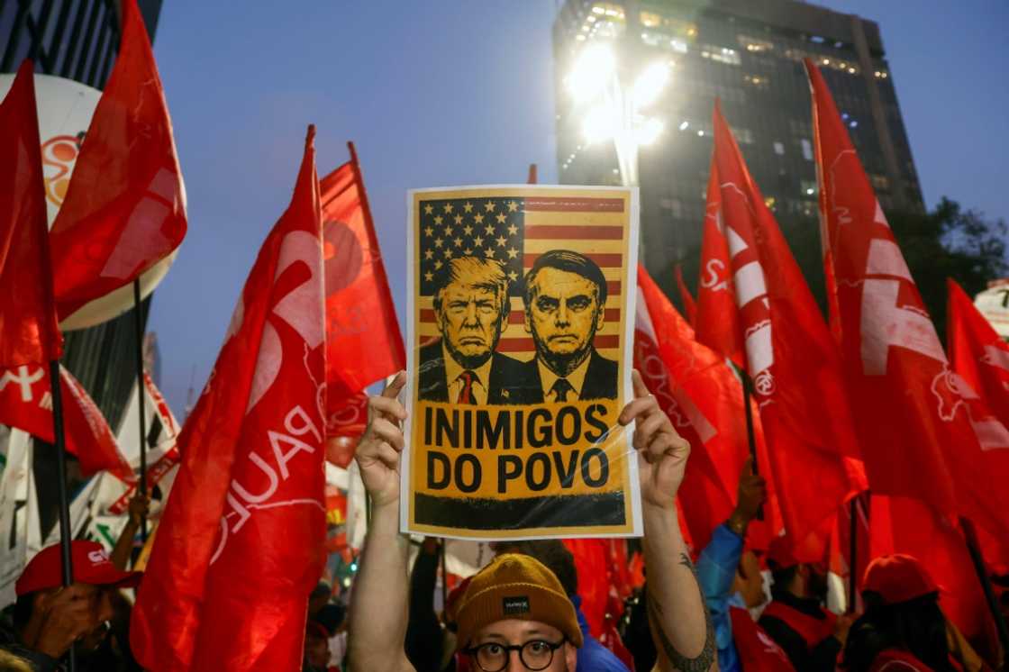 A poster declaring US President Donald Trump and former Brazilian President Jair Bolsonaro 'Enemies of the people' at a demonstration in Sao Paulo A poster declaring US President Donald Trump and former Brazilian President Jair Bolsonaro 'Enemies of the people' at a demonstration in Sao Paulo