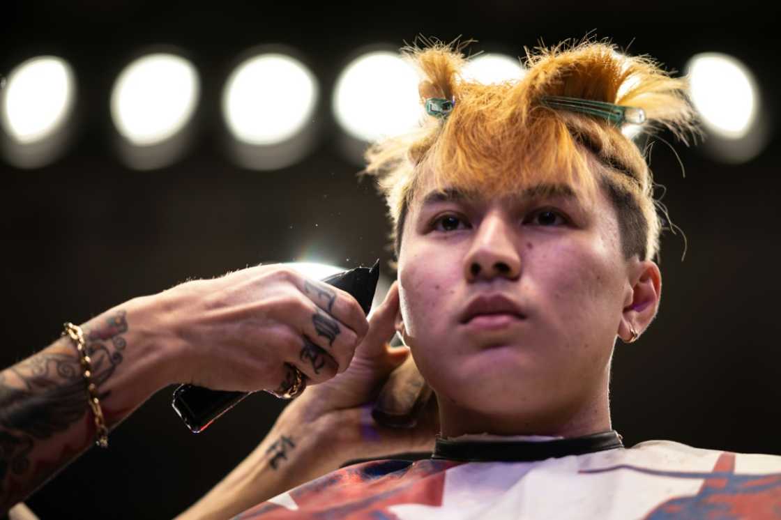 A barber gives a model a haircut during the World Barber Classic in Tokyo