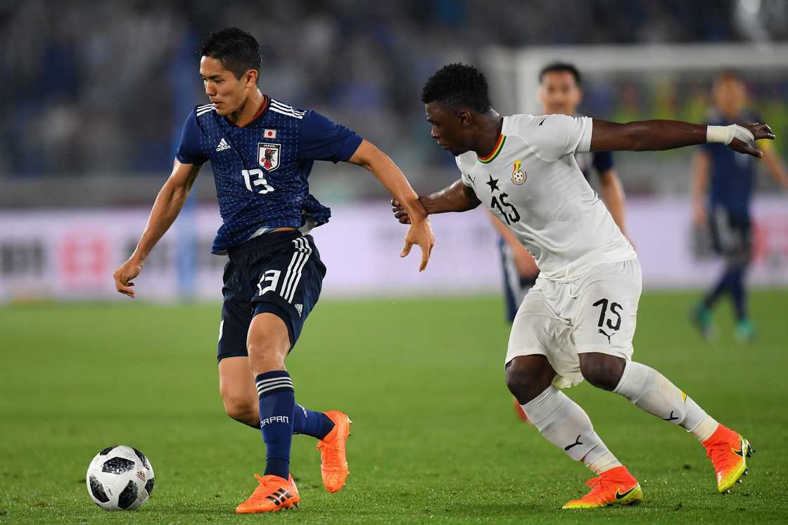 Yoshinori Muto of Japan and Rashid Sumaila of Ghana compete for the ball during the international friendly match between Japan and Ghana at Nissan Stadium on May 30, 2018 in Yokohama, Kanagawa, Japan Yoshinori Muto of Japan and Rashid Sumaila of Ghana compete for the ball during the international friendly match between Japan and Ghana at Nissan Stadium on May 30, 2018 in Yokohama, Kanagawa, Japan