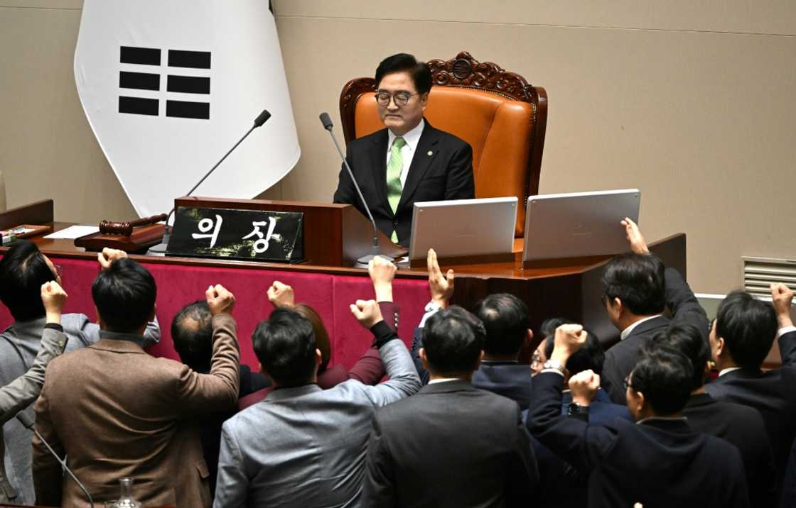 South Korea's ruling People Power Party lawmakers (bottom) argue with National Assembly Speaker Woo Won-shik (C top) during a parliamentary session