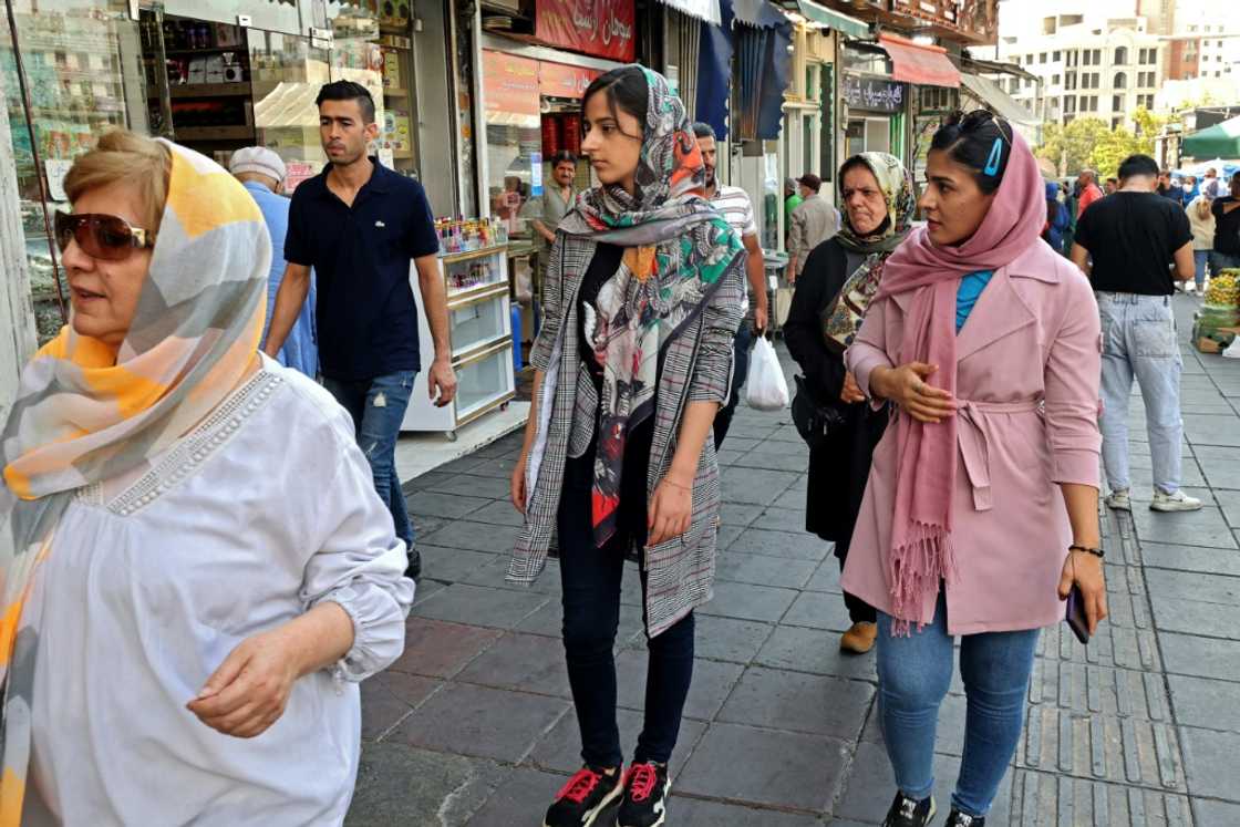 Iranian women shop in the capital Tehran on Tuesday: women, must wear a headscarf covering their hair in public Iranian women shop in the capital Tehran on Tuesday: women, must wear a headscarf covering their hair in public