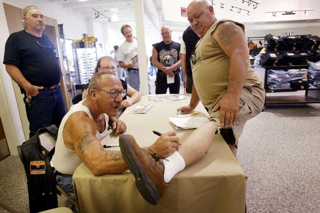 Barger autographs the artificial leg of Kenny Little during an event at a Harley-Davidson motorcycle dealership in 2003 Barger autographs the artificial leg of Kenny Little during an event at a Harley-Davidson motorcycle dealership in 2003