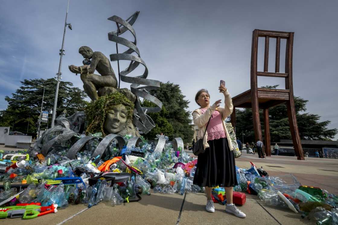 "The Thinker's Burden" statue by Canadian artist Benjamin Von Wong will gradually be covered by plastic waste outside the Geneva negotiations for a UN plastics treaty