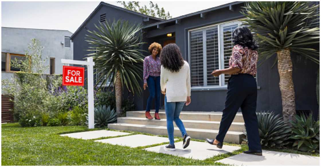 An agent accompanies a lady to view a property. Photo credit: Getty Images. Source: Getty Images