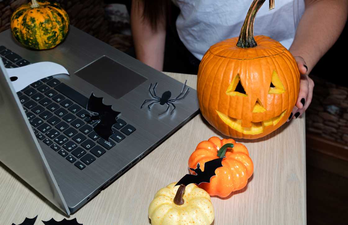 A worker ready to play pumpkin game during Halloween in an office A worker ready to play pumpkin game during Halloween in an office