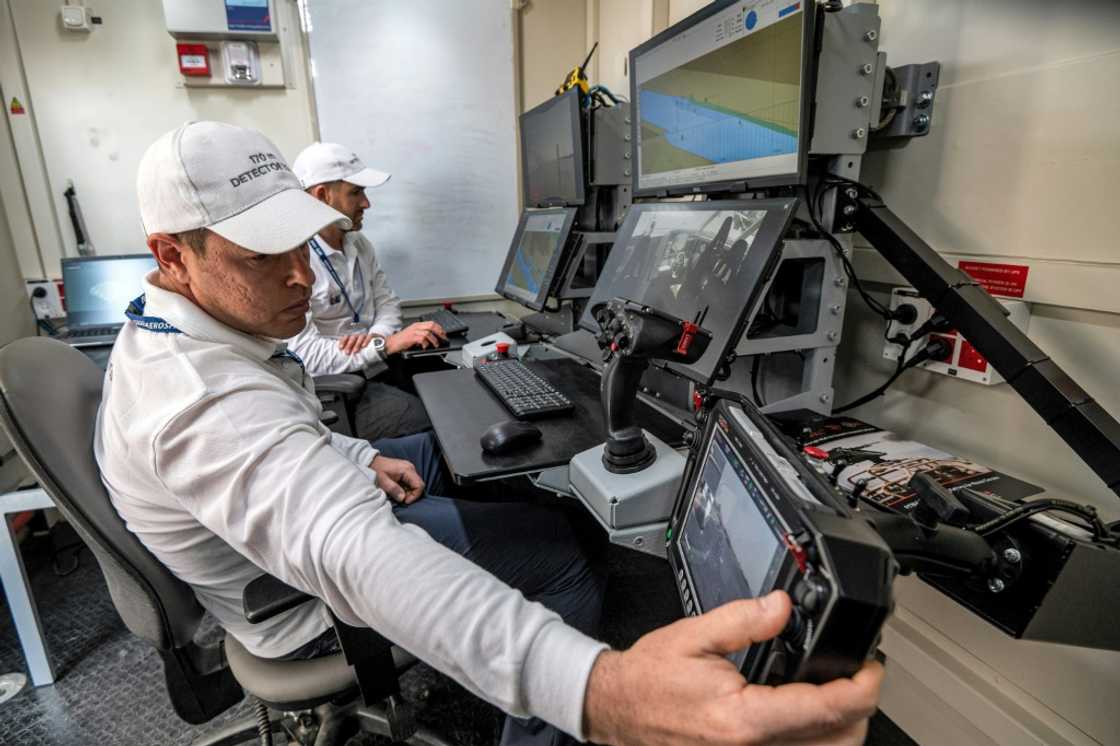 Controllers man a terminal at the command station of the Israel Aerospace Industries in an unmanned maritime demonstration during the Naval Defence and Maritime Security Exhibition (NAVDEX) at the Abu Dhabi International Exhibition Centre