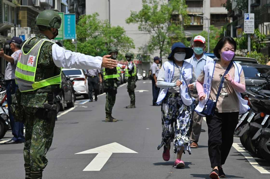 Civilians clear the streets in Taipei as part of an air-raid drill Civilians clear the streets in Taipei as part of an air-raid drill