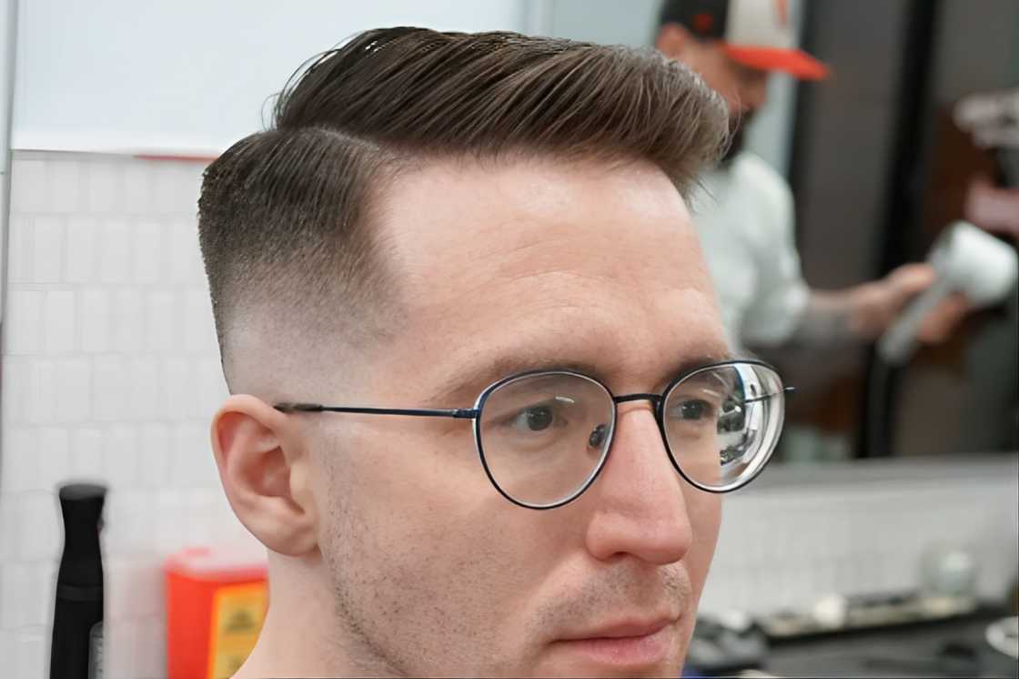 A side-parted comb over hairstyle on a man with a big forehead A side-parted comb over hairstyle on a man with a big forehead