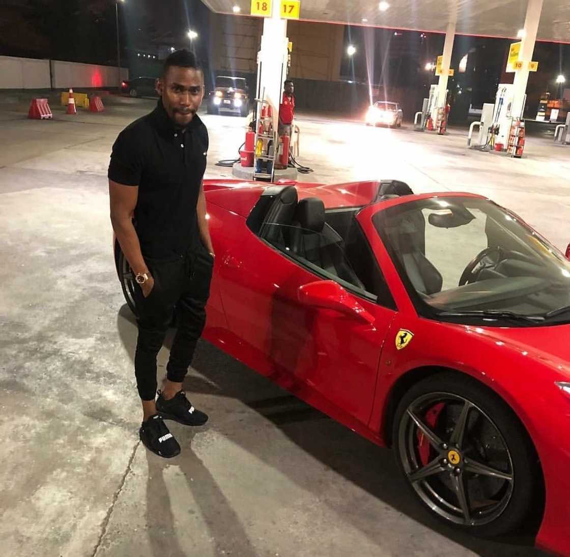 A man standing beside a car