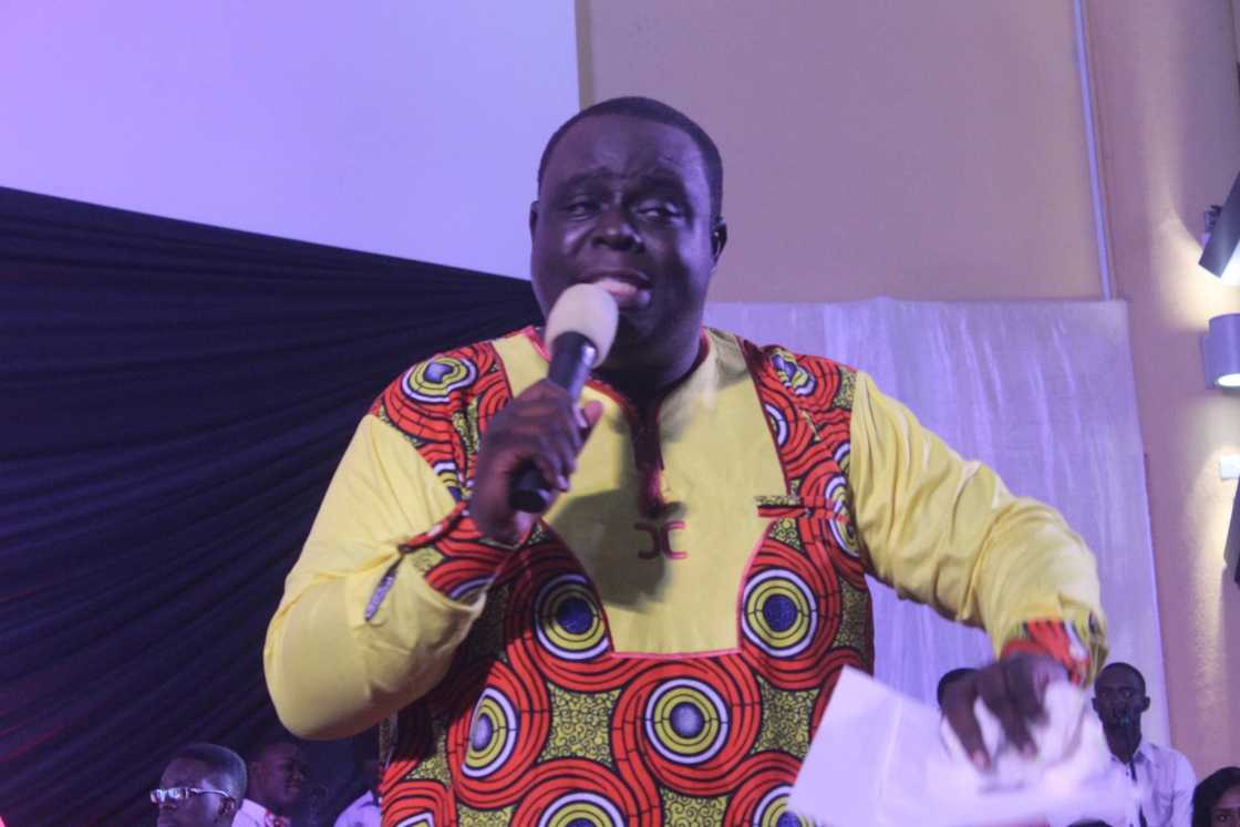 A man holding a microphone A man holding a microphone