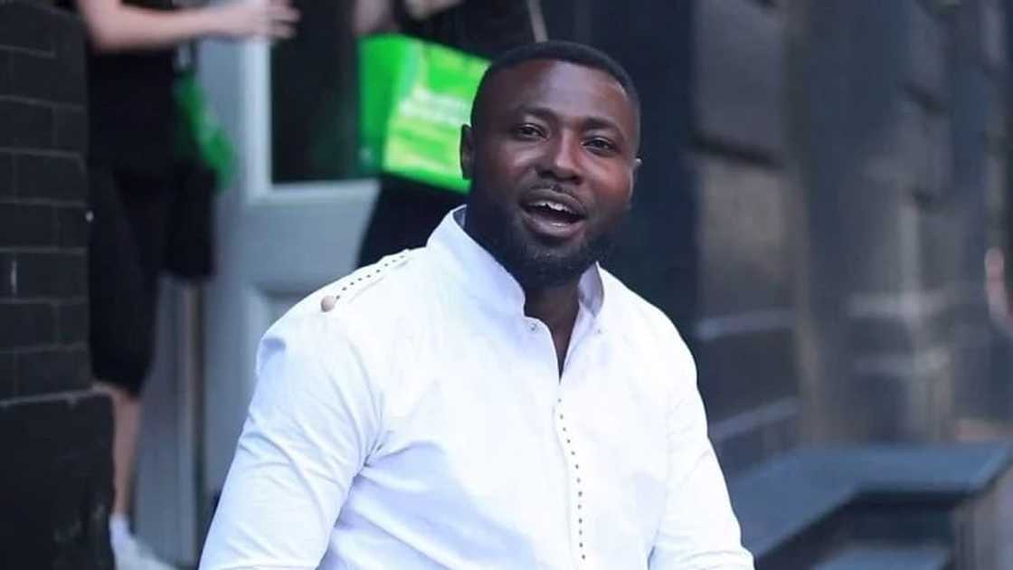 The Ghanaian actor, Bernard Aduse Poku wearing a white shirt