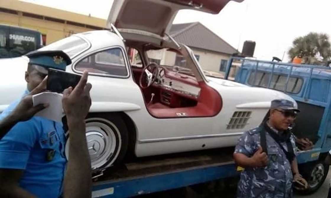 White Mercedes Benz surrounded by police personnel