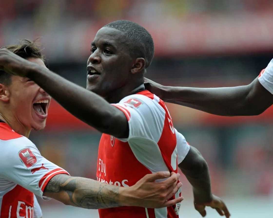 A footballer with his arm stretched A footballer with his arm stretched