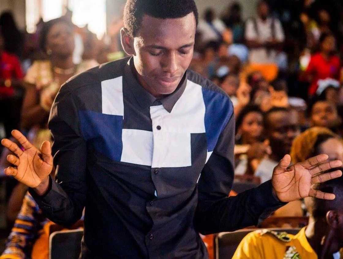 A man lifting up his hands in prayer A man lifting up his hands in prayer