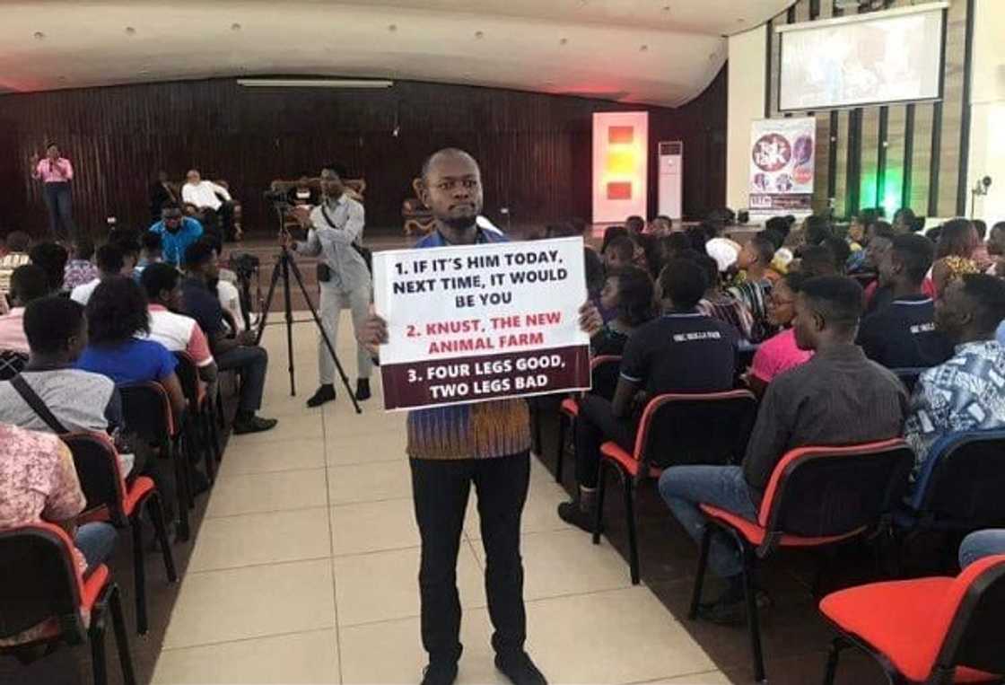 A man holding a placard A man holding a placard