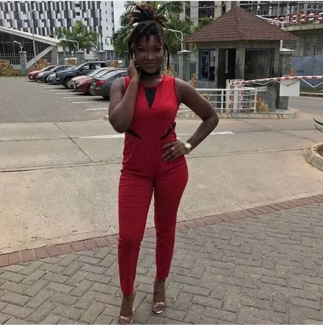 Ebony Reigns in red jumpsuit smiling