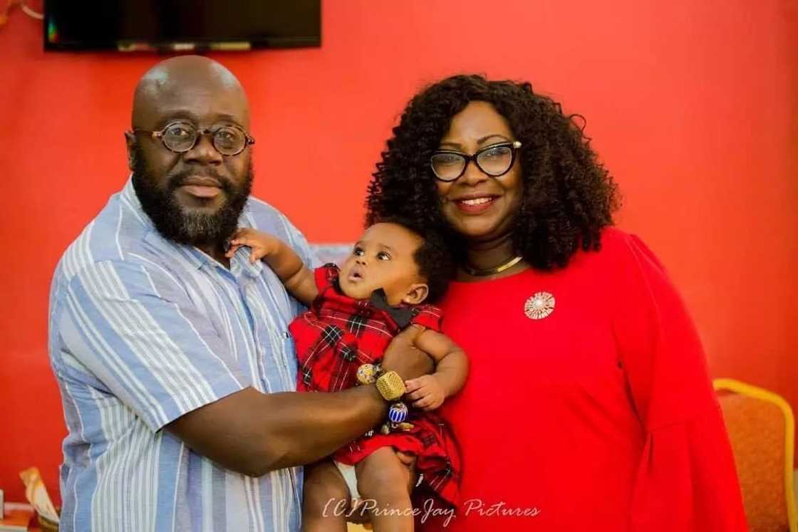 Gifty Anti with a man holding her baby Gifty Anti with a man holding her baby