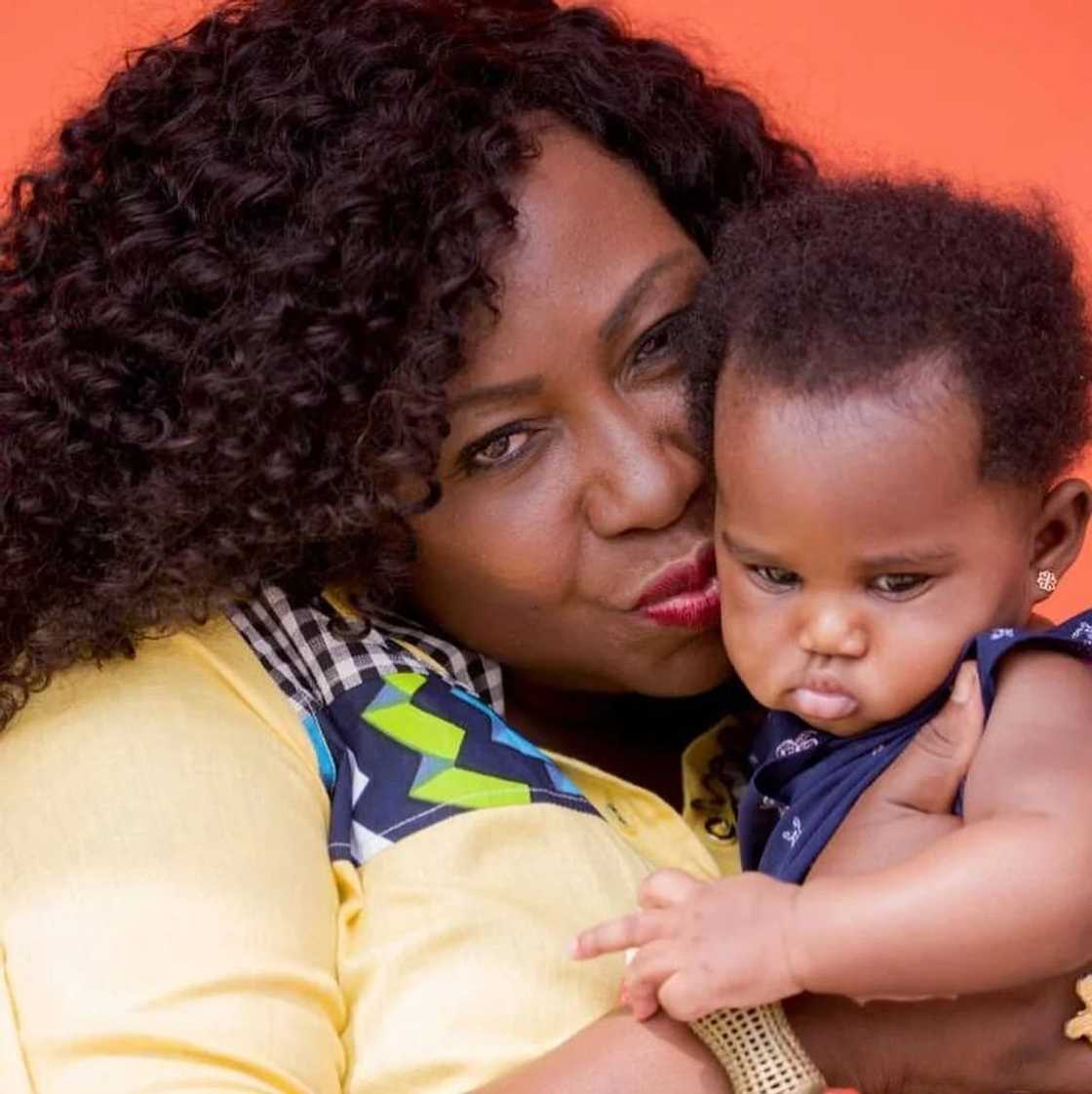 Gifty Anti hugs her baby Gifty Anti hugs her baby