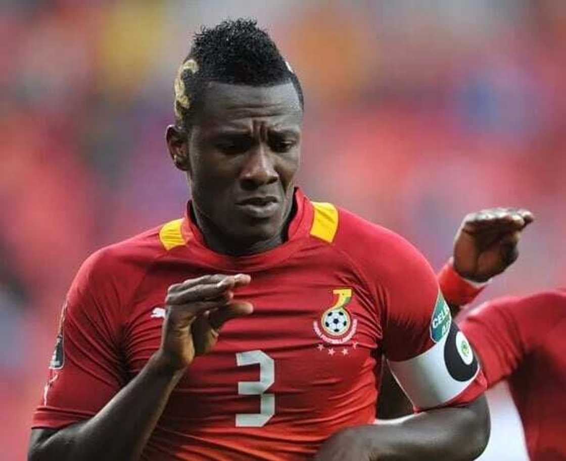 Asamoah Gyan makes a dance move with his hand