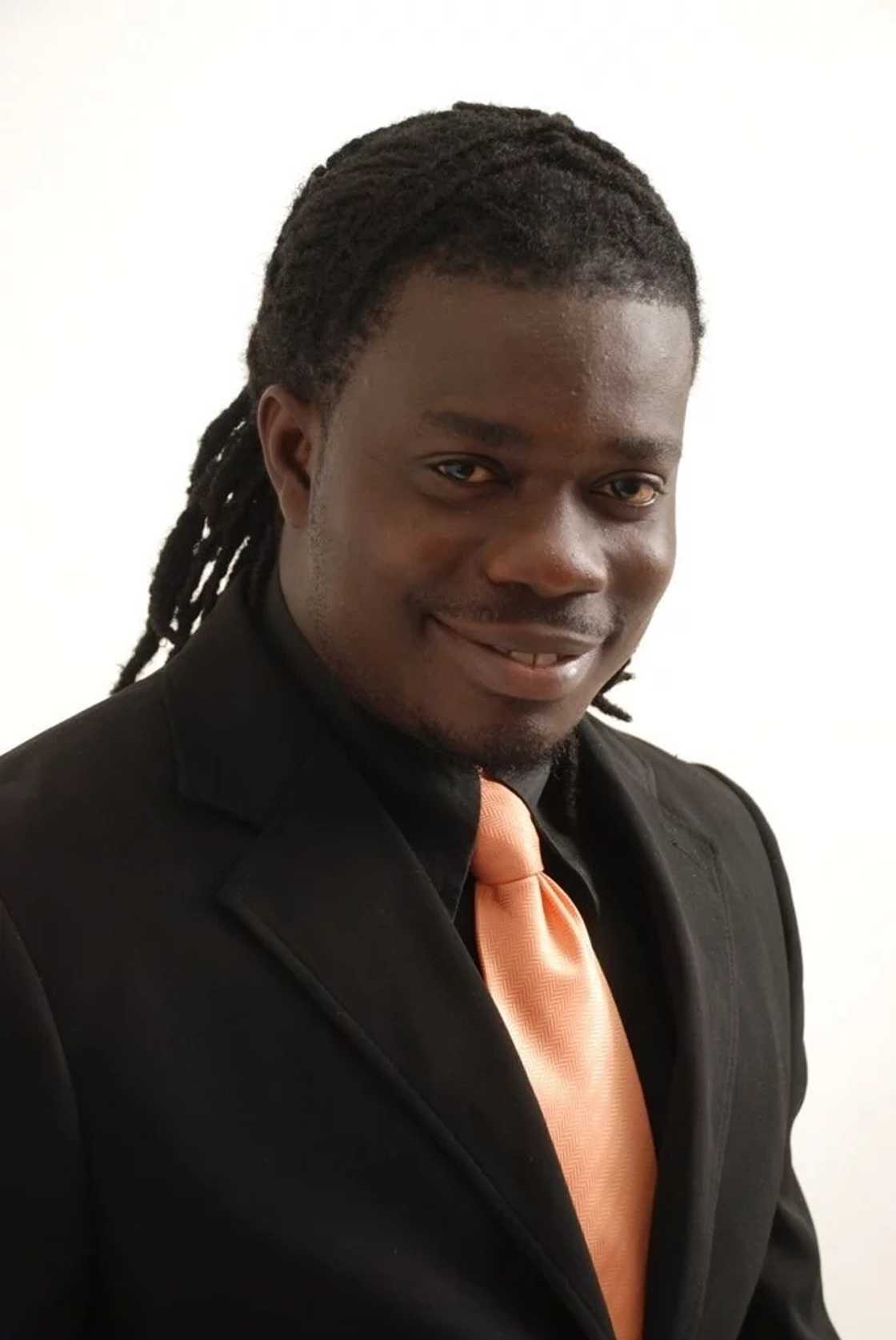 MUSIGA president in a black suit and pink tie