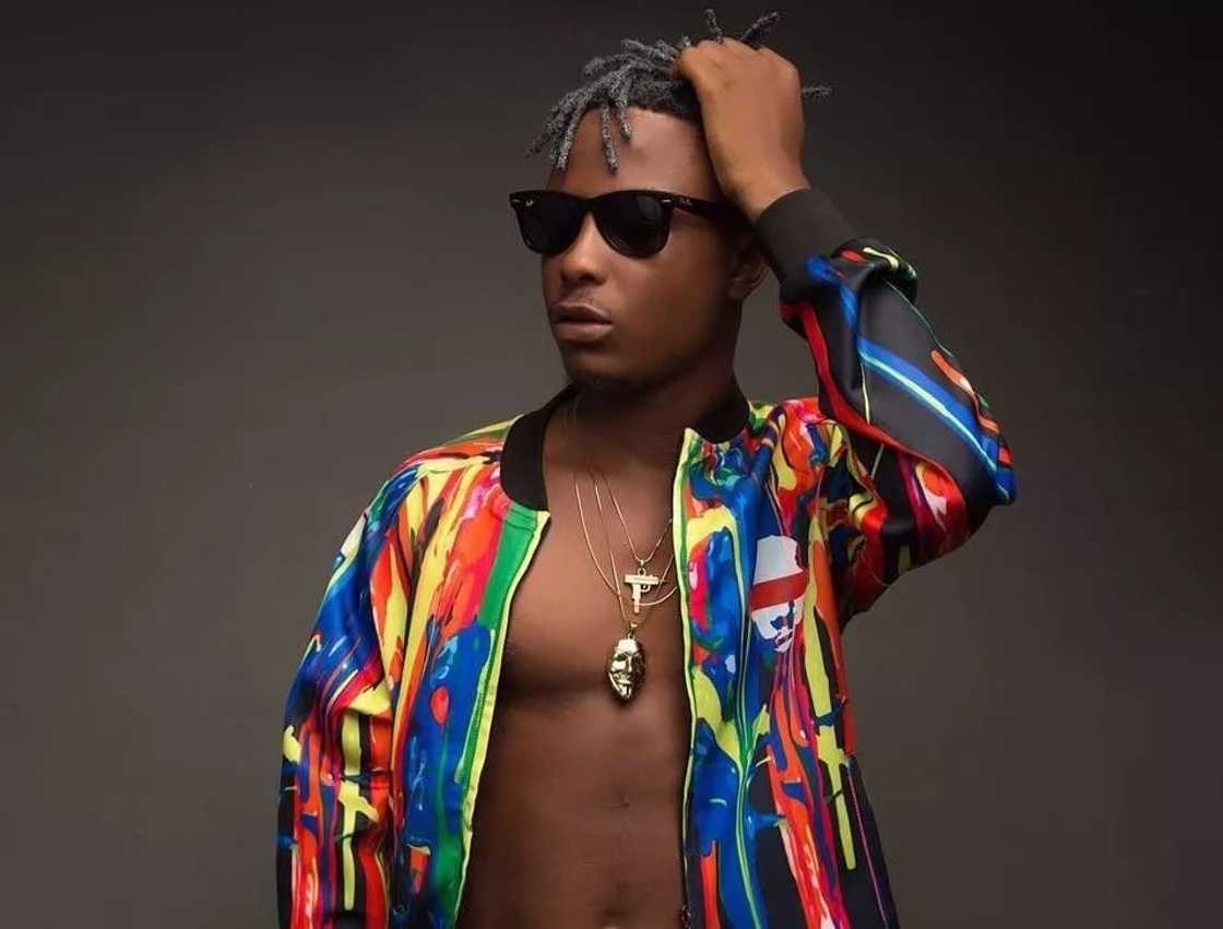 A man wearing a multi-coloured shirt A man wearing a multi-coloured shirt