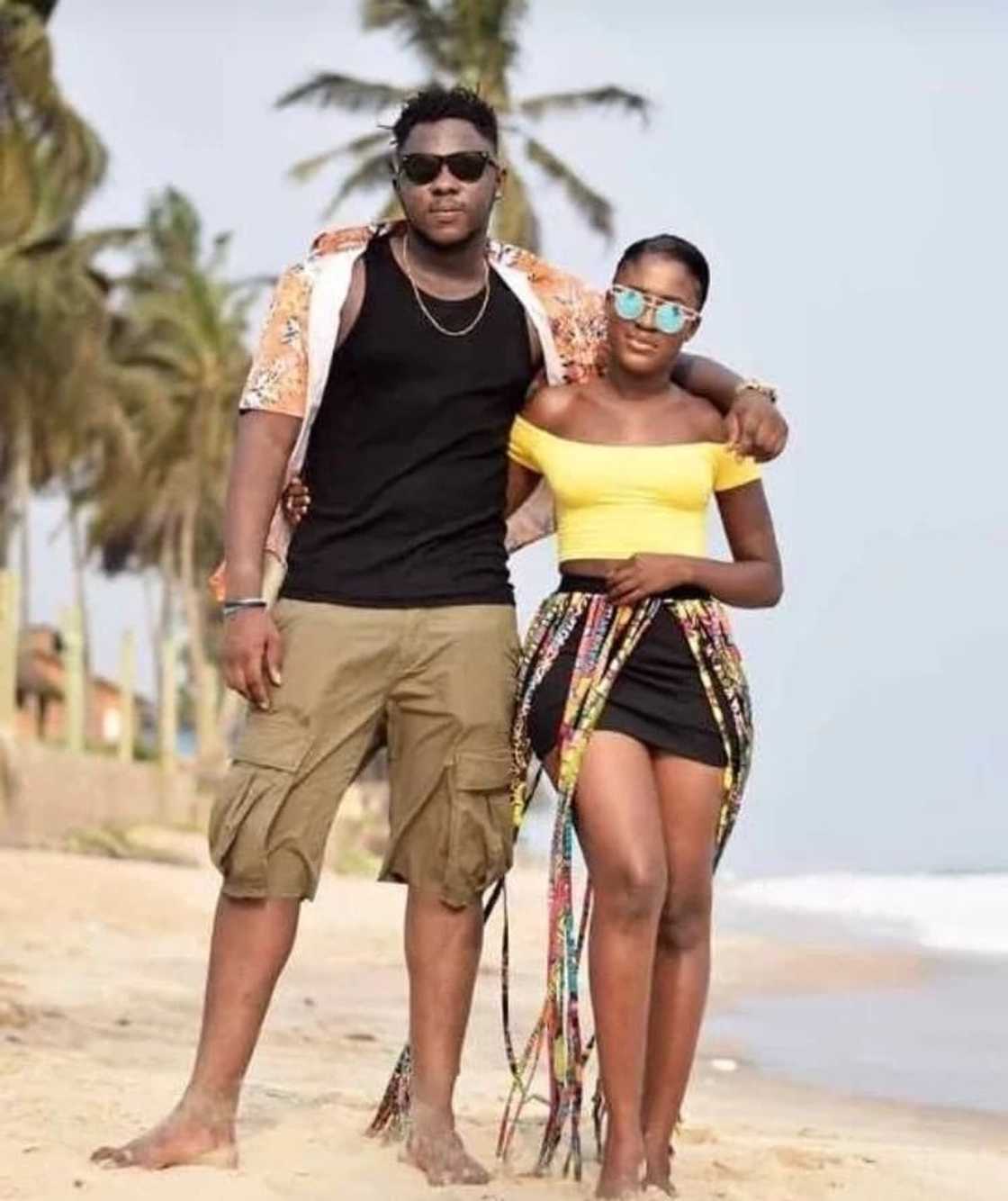 Ghanaian man and woman stand together on a beach Ghanaian man and woman stand together on a beach