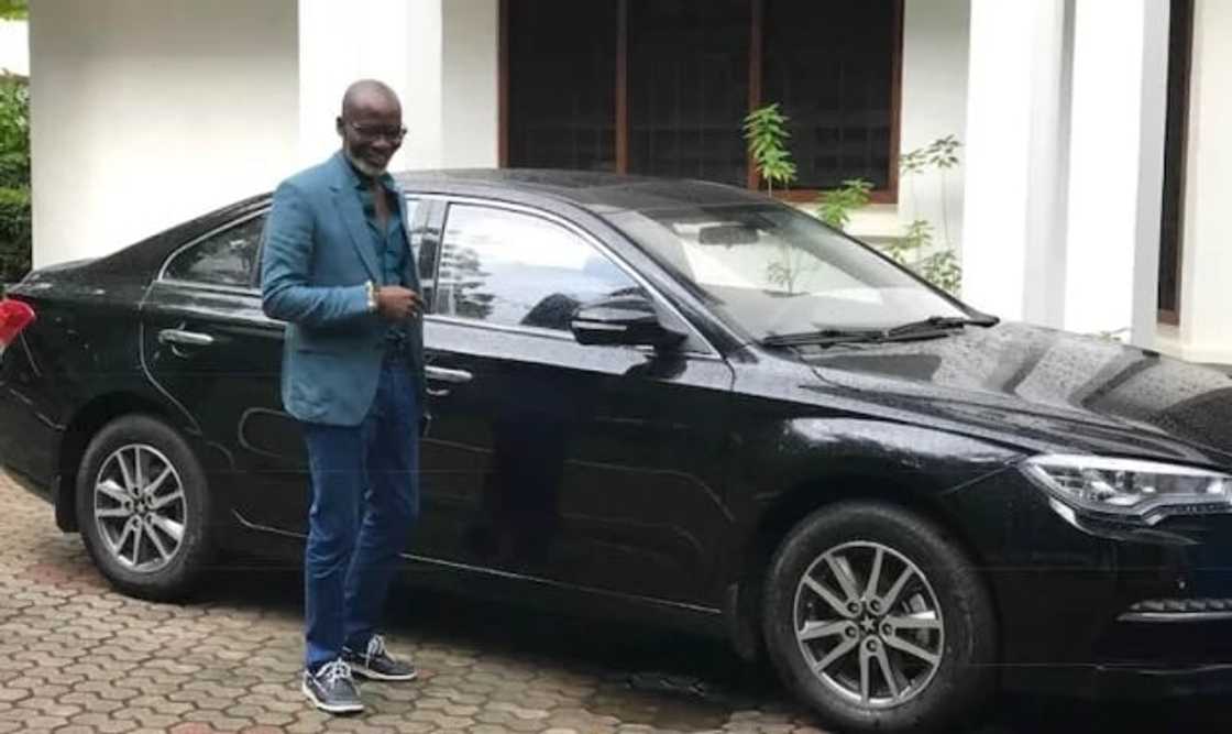 Gabby Otchere-Darko standing beside a Kantanka salon car