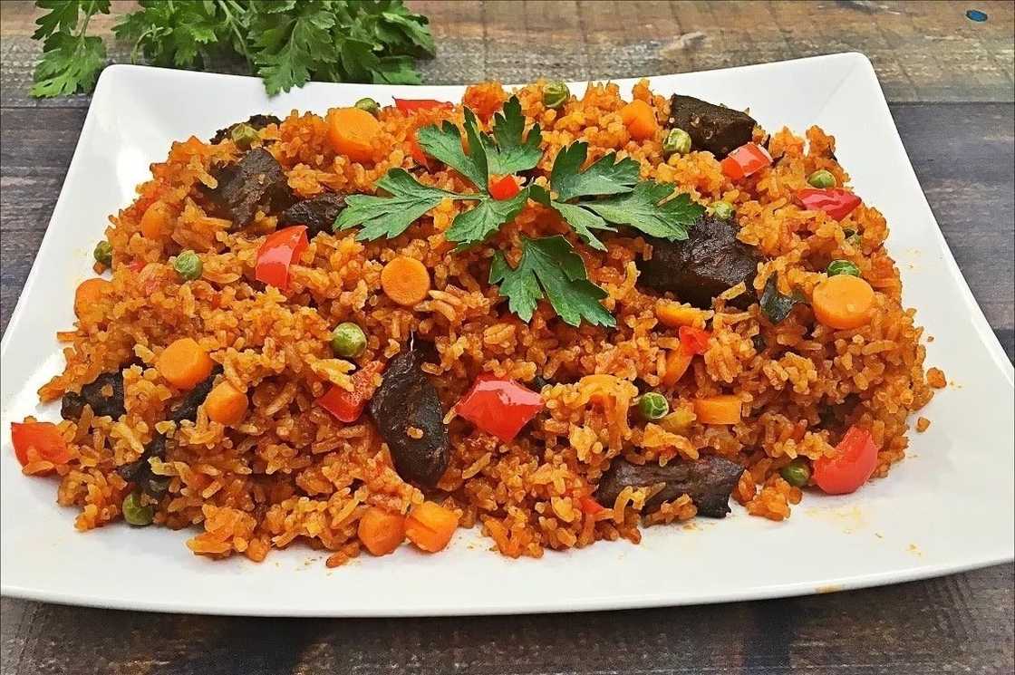 Jollof rice served with meat and peppers