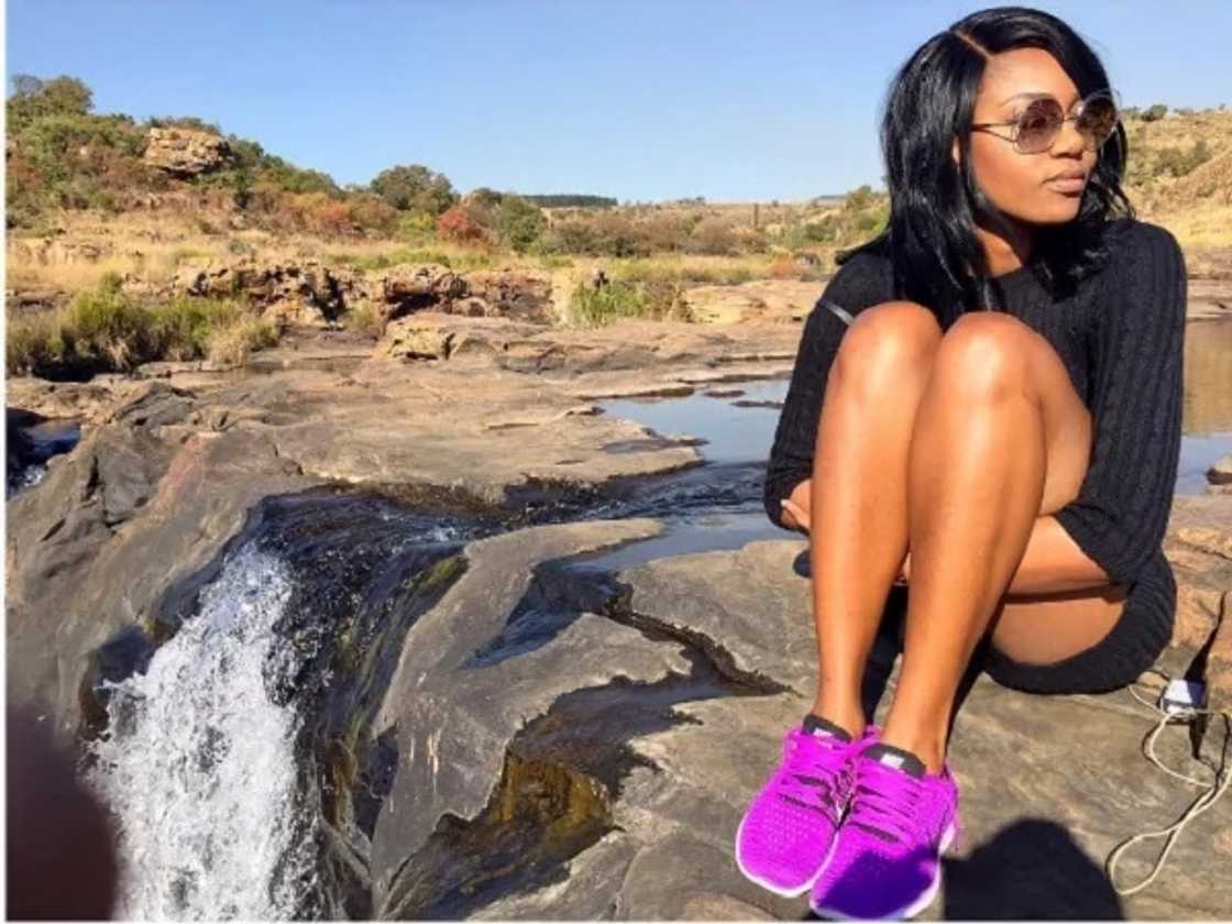 A womans seated on a rock A womans seated on a rock