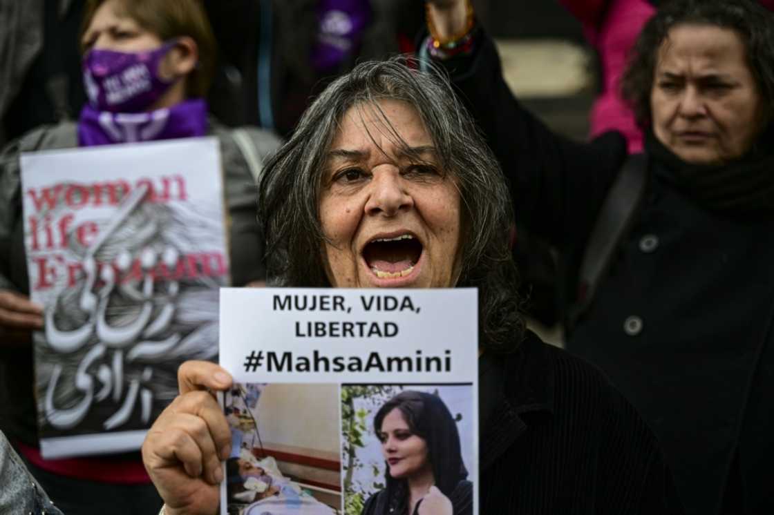 A woman holds a picture of Amini during a demonstration in Santiago, Chile A woman holds a picture of Amini during a demonstration in Santiago, Chile