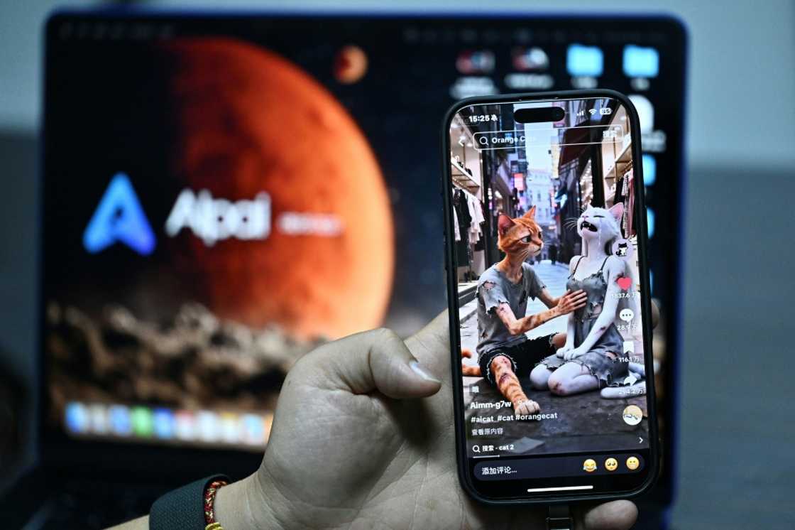 Chen Kun showing content generated by his AIpai platform on a smartphone during an AFP interview at his office in Beijing