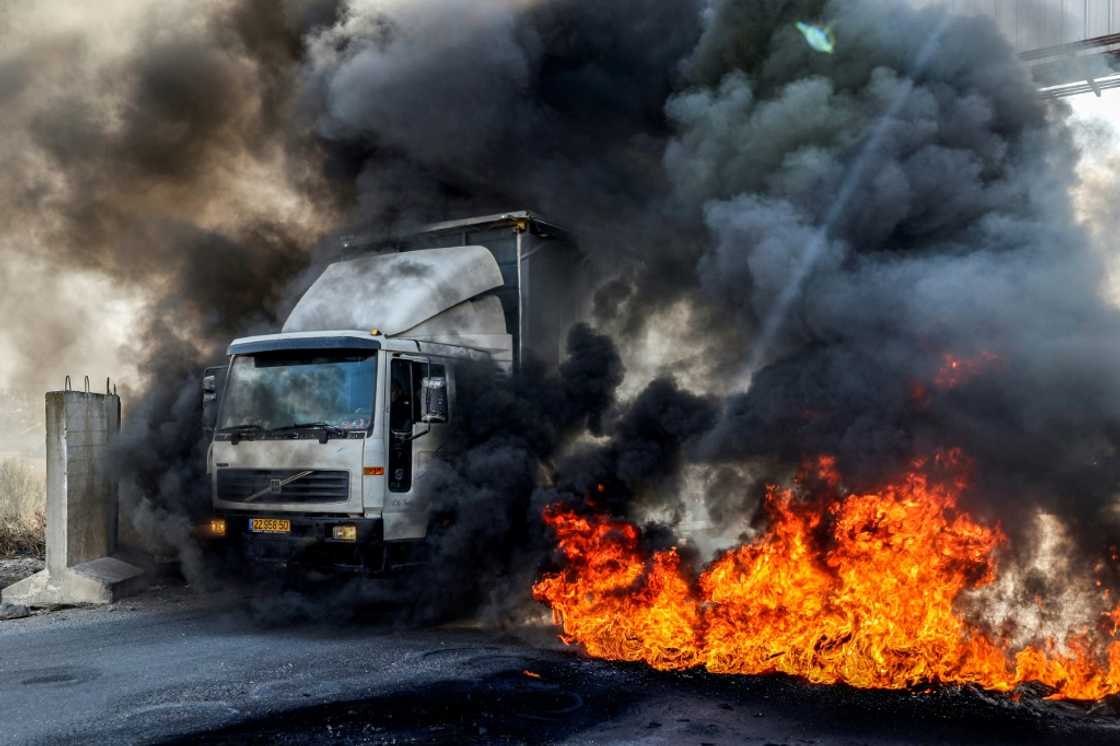 A truck headed towards Nablus drives past tyres set on fire by protesters in the occupied West Bank on November 1: the United Nations says recent months have been the deadliest period in years in the West Bank A truck headed towards Nablus drives past tyres set on fire by protesters in the occupied West Bank on November 1: the United Nations says recent months have been the deadliest period in years in the West Bank