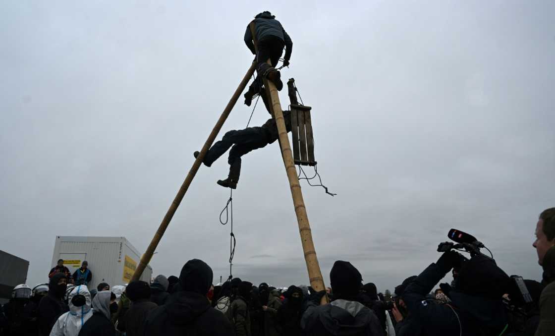 The activists in Luetzrath have set up an intricate, self-built camp in the trees, linked by a network of ropes and cables, which has been designed to make evacuation difficult The activists in Luetzrath have set up an intricate, self-built camp in the trees, linked by a network of ropes and cables, which has been designed to make evacuation difficult