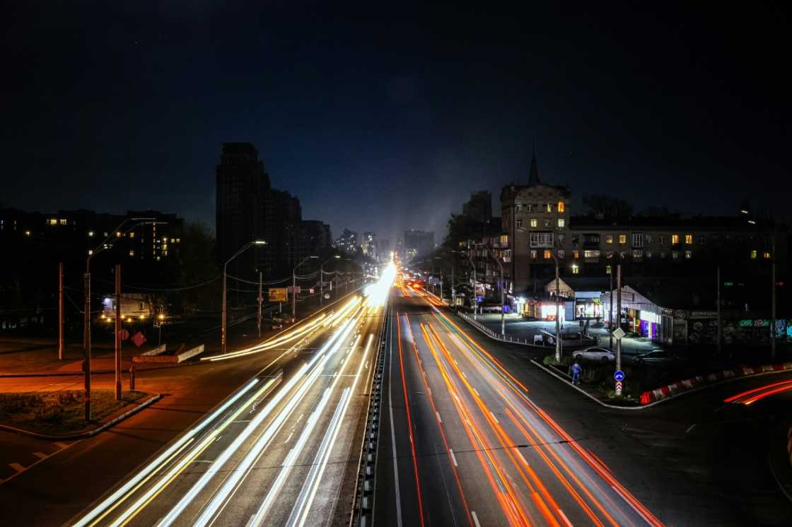 Cars drive during a blackout in Kyiv