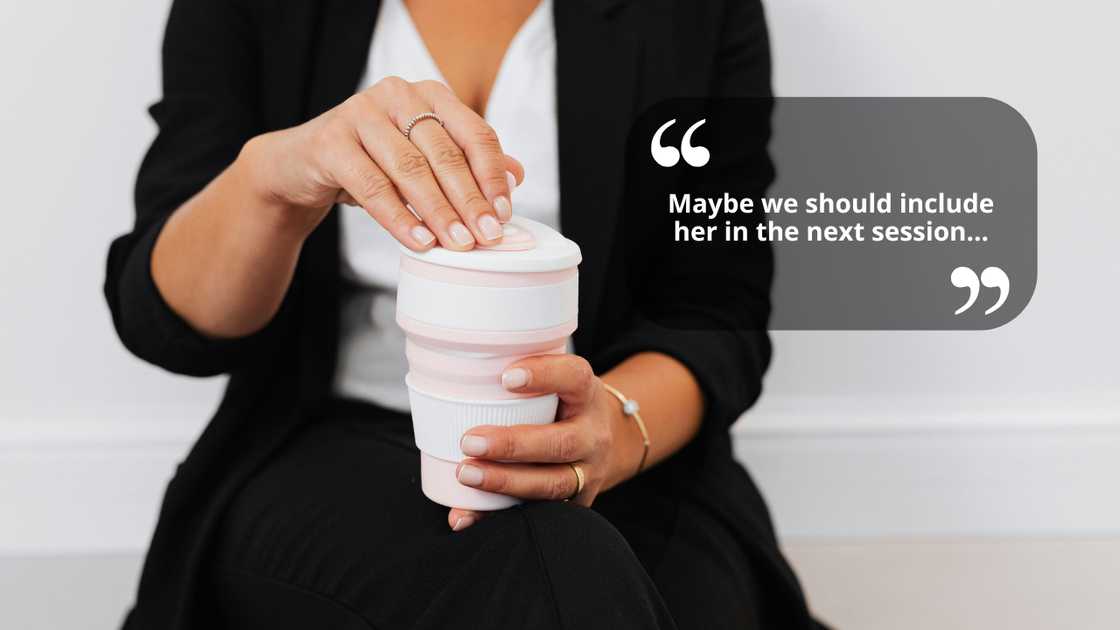 A woman talking as she holds a cup on her hands A woman talking as she holds a cup on her hands