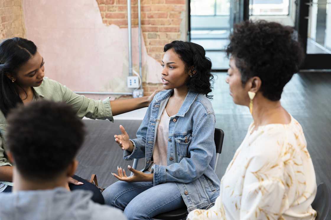 A woman speaking in a parent mentoring group. A woman speaking in a parent mentoring group.