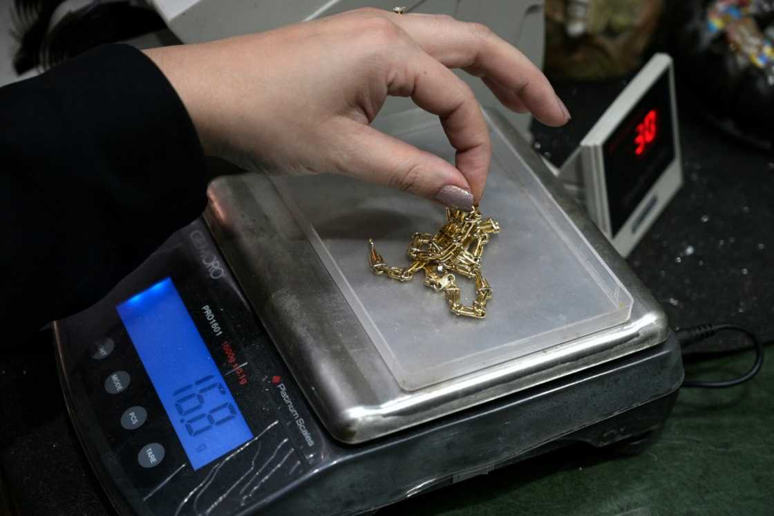 An appraiser weighs gold jewelry in Buenos Aires An appraiser weighs gold jewelry in Buenos Aires