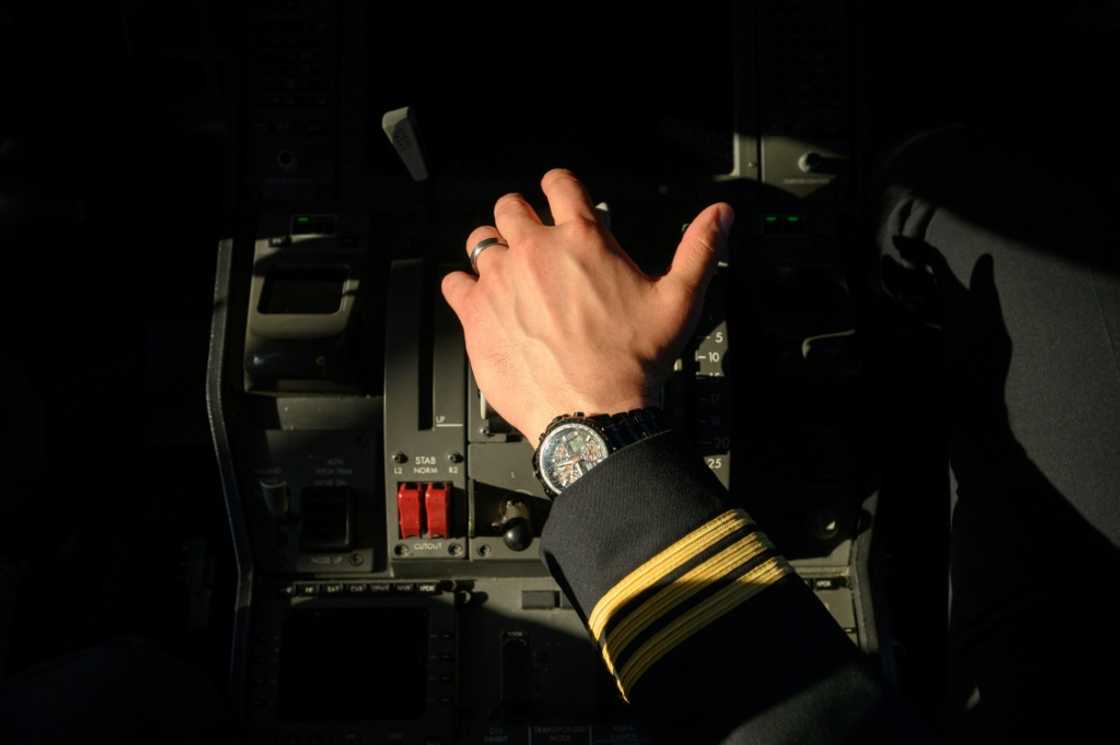 A pilot holds the thrust controls of a United Airlines Boeing 787 aircraft at Newark Liberty International Airport in Newark, New Jersey