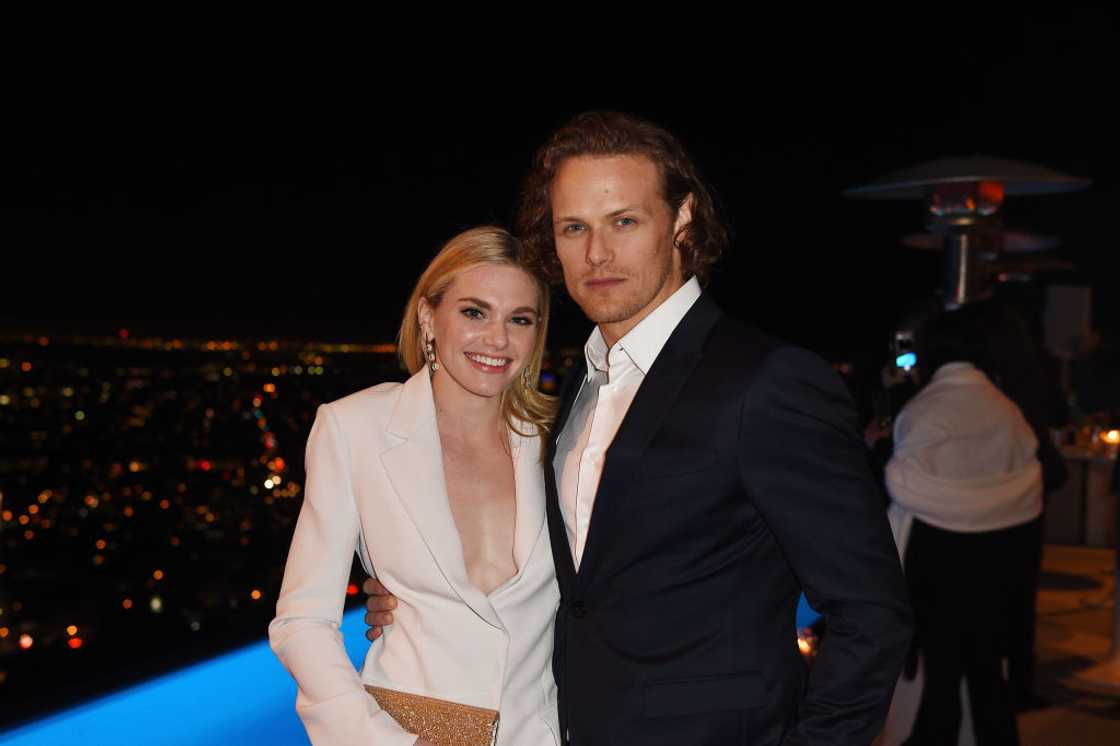 Mackenzie Mauzy and Sam Heughan at a cocktail party in Los Angeles, California.