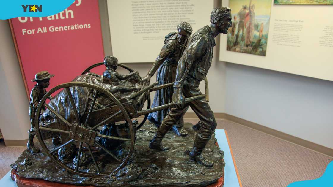 A bronze statue depicts a Mormon pioneer family pulling their handcart across the plains to Utah. A bronze statue depicts a Mormon pioneer family pulling their handcart across the plains to Utah.