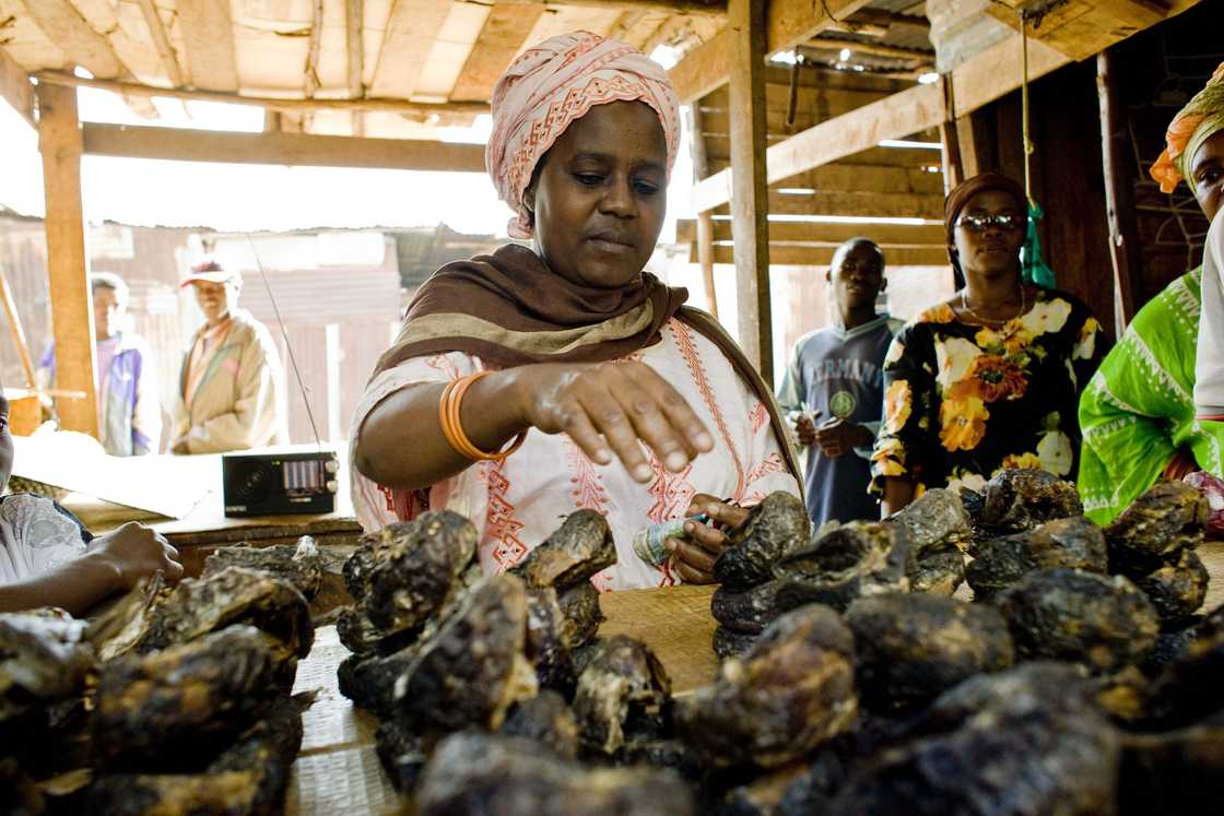 A woman buying smoked fish in the market