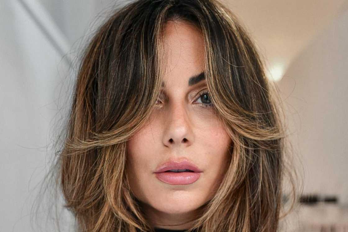 Layered midlength haircut + curtain fringe with soft golden highlights