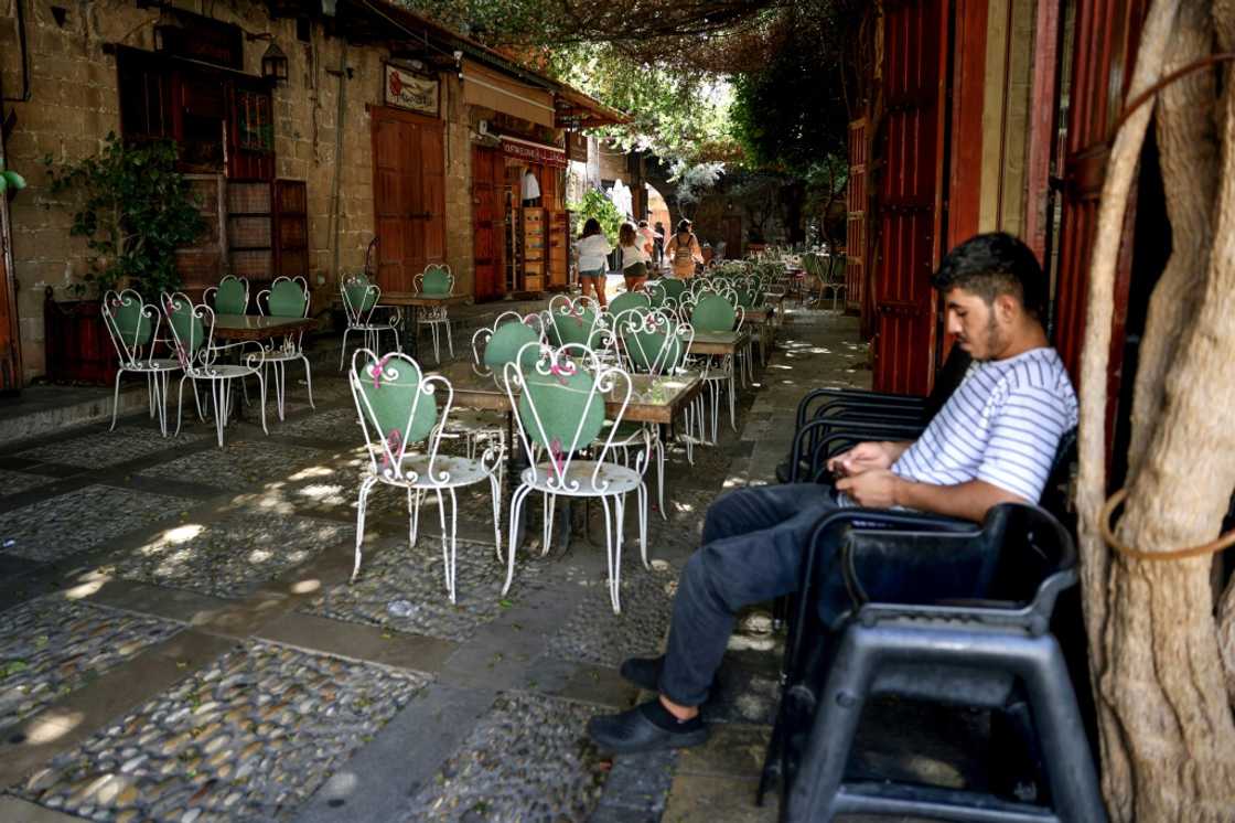 Waiting for customers at an empty restaurant in Lebanon's historic city of Byblos Waiting for customers at an empty restaurant in Lebanon's historic city of Byblos