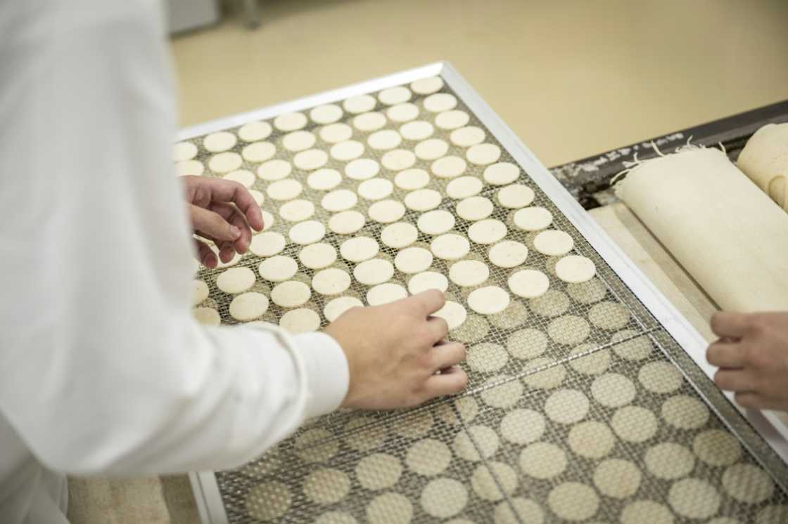 Kameda Seika employees making rice crackers samples at the testing centre of the company's headquarters in Niigata city, Niigata prefecture