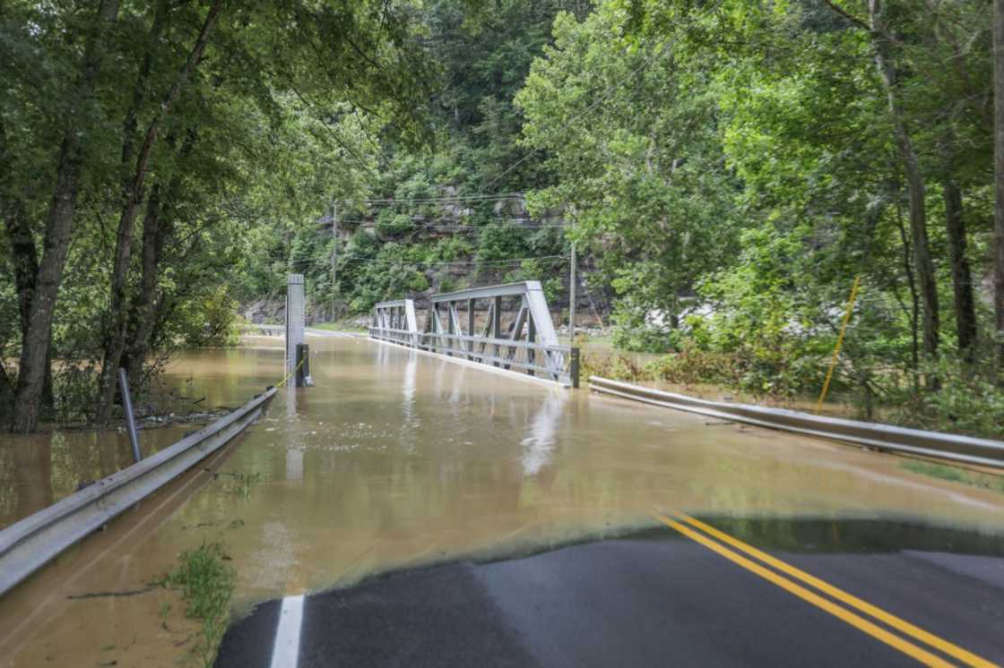 A bridge and a road are submerged by floodwaters from the North Fork of the Kentucky River in Jackson, Kentucky A bridge and a road are submerged by floodwaters from the North Fork of the Kentucky River in Jackson, Kentucky