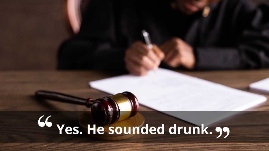 A judge writes on legal documents, slightly out of focus.