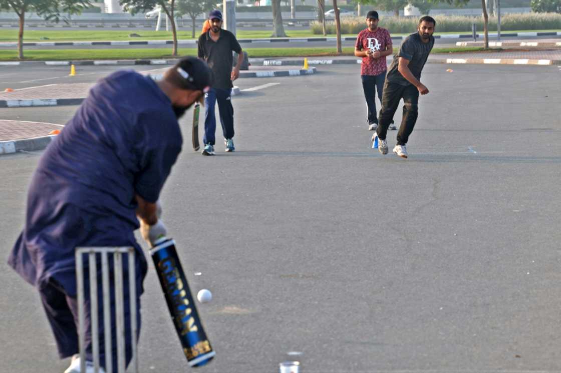 Expatriate workers play cricket in a parking lot in the Gulf emirate of Dubai Expatriate workers play cricket in a parking lot in the Gulf emirate of Dubai