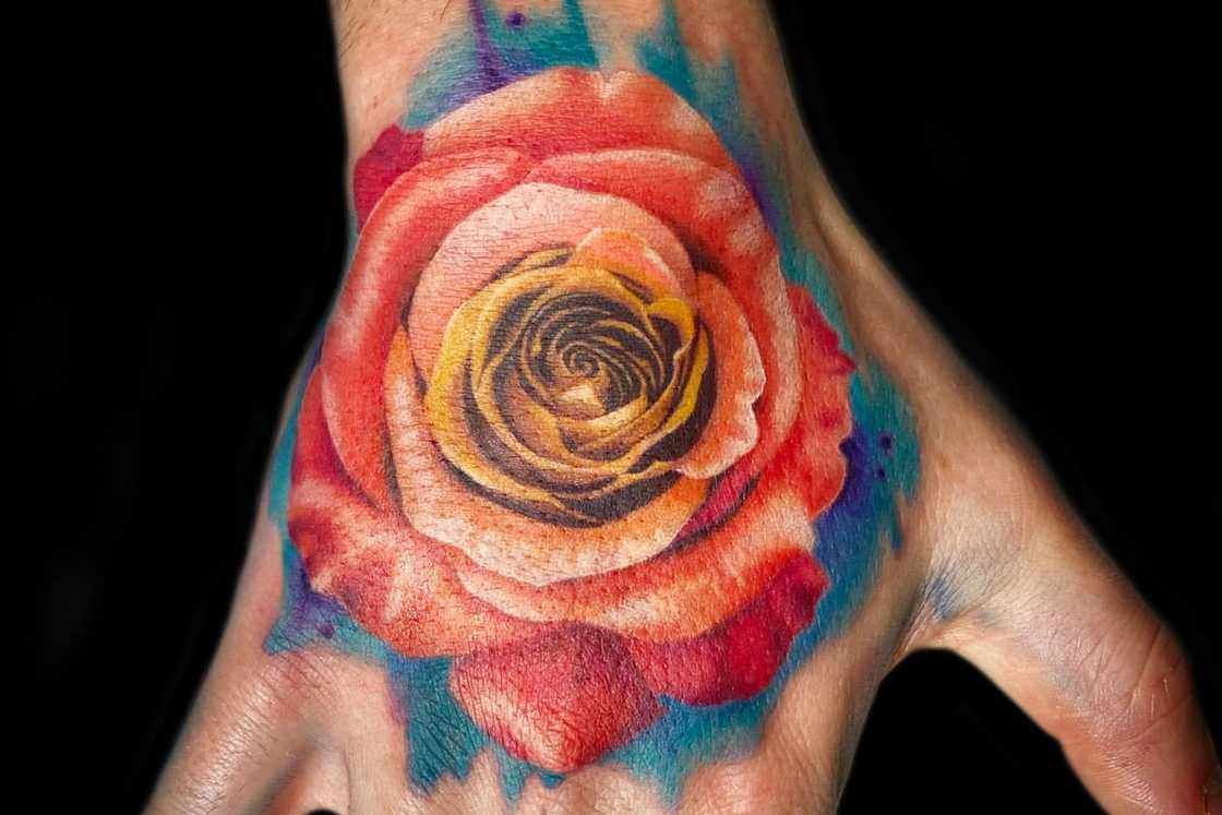 Hand tattoo with a realistic colour rose Hand tattoo with a realistic colour rose